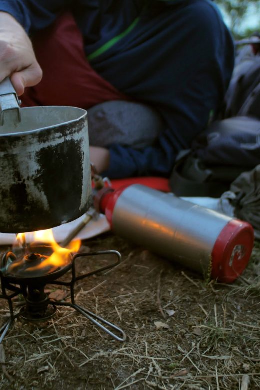 female hiker cooking outdoors