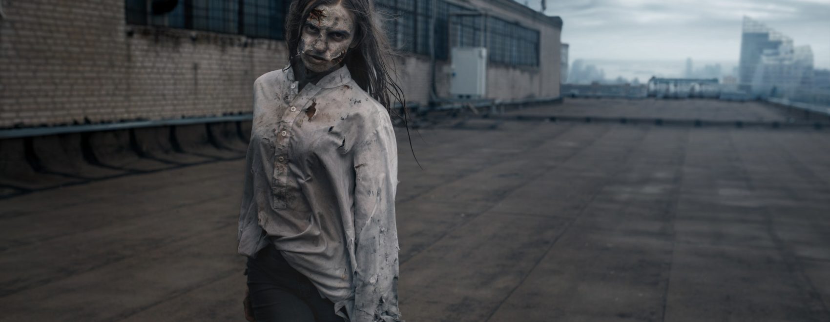Female zombie on the roof of abandoned building