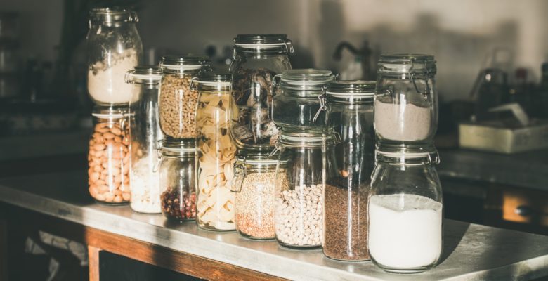 Grains, cereals, nuts, dry fruit, pasta in jars in kitchen