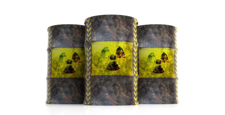 Radiation symbol on oil barrels, white background. 3d illustration